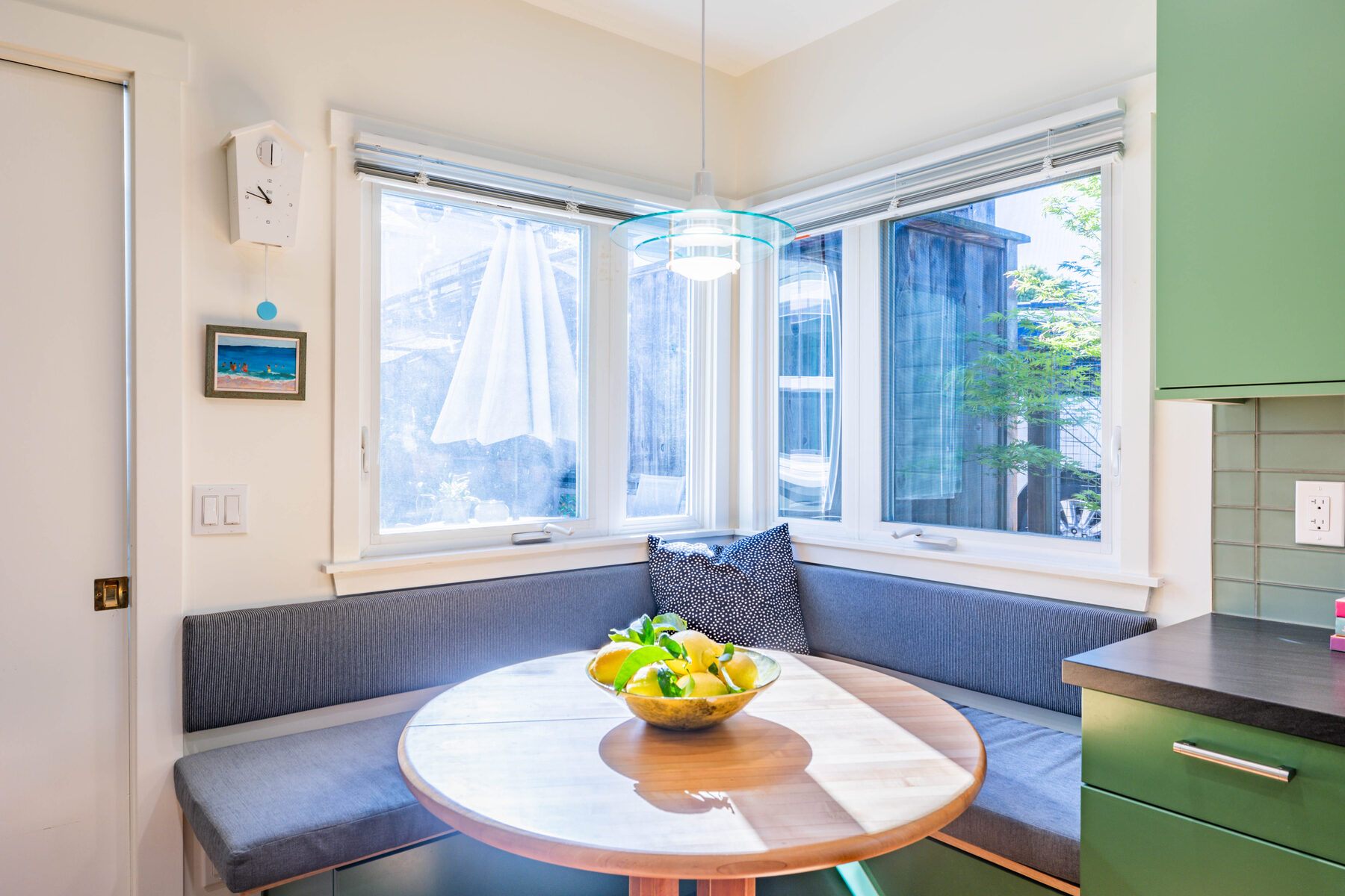 Built-in banquette nook with bay window and lemon bowl