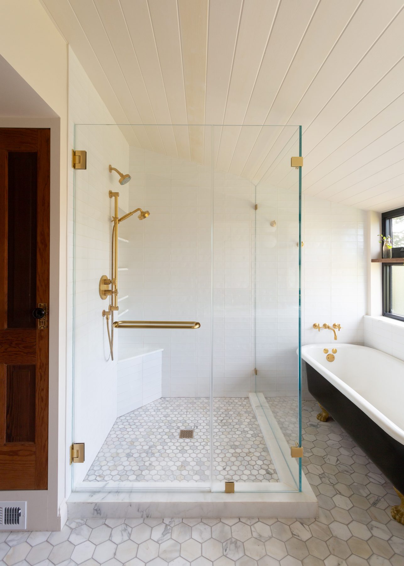 Morton Street Residence brass-fitted glass shower beside a black clawfoot tub